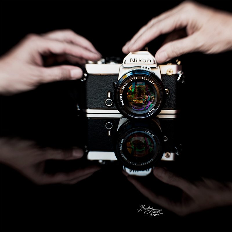 Nikon FM Reflected in black glass | Lensbaby Composer Pro Sweet 35